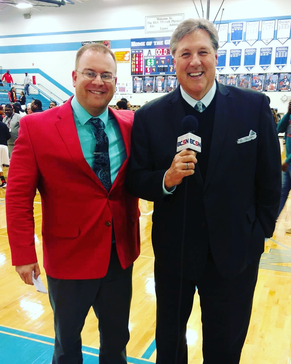 Tim Clagg with a BCSN broadcast partner in a high school gymnasium