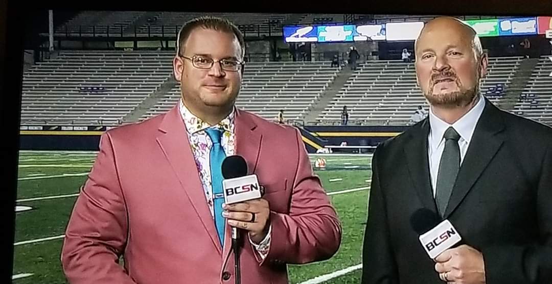 Tim Clagg and his BCSN partner on camera with microphones during a stadium pregame broadcast