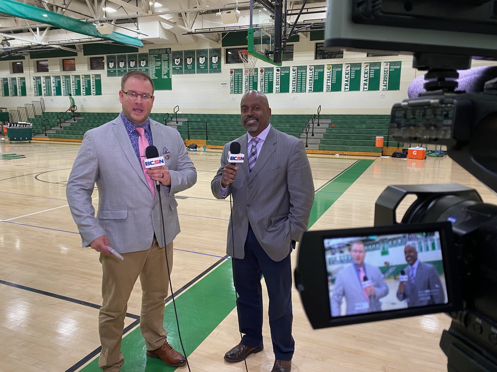 Tim Clagg and his BCSN broadcast partner on camera at center court before a high school basketball game