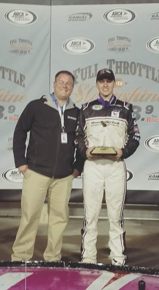 Tim Clagg in victory lane with a race winner holding a trophy